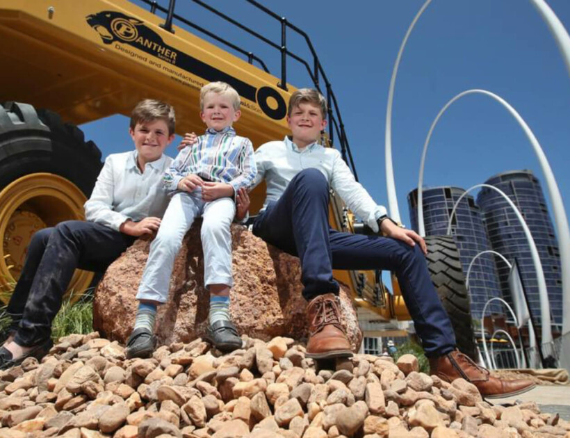 Thomas, 9, James, 5, and Harry Piacentini, 11, in front of the Panther II Series Low Loader manufactured in Bunbury by their family's business, Piacentini & Son.